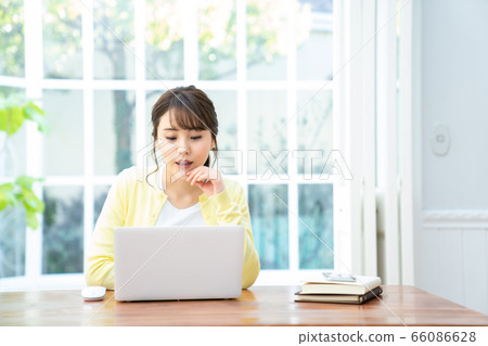 Young lady who operates personal computer internet girls lifestyle female portrait 66086628