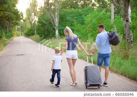 Young family traveller hitch hiking on empty road Young family traveller hitch hiking on empty road 66088846