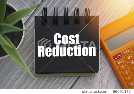 COST REDUCTION text with calculator, decorative COST REDUCTION text with calculator, decorative 66091372