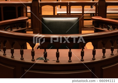 A witness stand with a black seat in the court room infront of tribunal when witness testify of evidence to judge, they will sit at here for testimony of witnesses, it is vintage or retro style 66094111