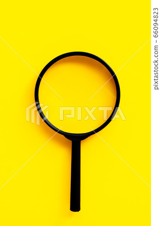 Magnifying glass on yello background. 66094823