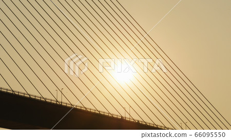 Steel cables of the bridge against the sunset. Bridge in Ha Long city. 66095550