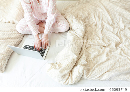 Mobile Office at home. Young woman in pajamas Mobile Office at home. Young woman in pajamas 66095749