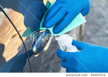 Hands of man in blue protective gloves is spraying Hands of man in blue protective gloves is spraying 66095918