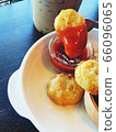 Chicken nugget dipping tomato sauce with iced coffee 66096065