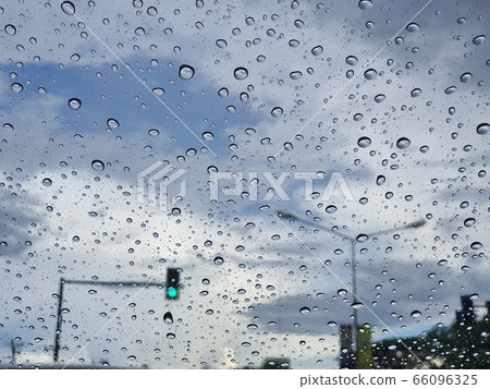 Dark sky raining with water drops 66096325
