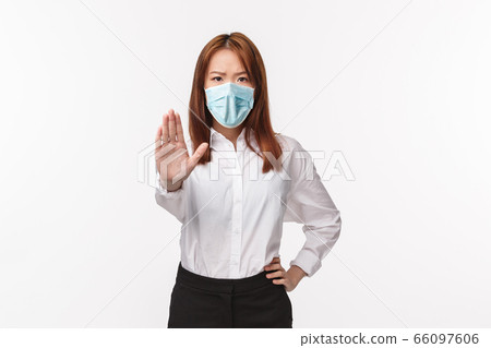 Please stop, dont trespass. Serious-looking angry and displeased asian female trying prevent rule validation, pull hand forward in prohibition disapproval gesture, give warning, white background 66097606