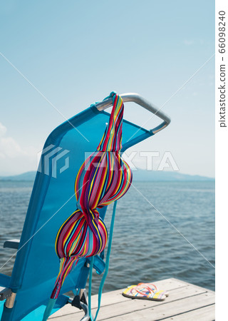 bikini drying on a deck chair on a pier bikini drying on a deck chair on a pier 66098240