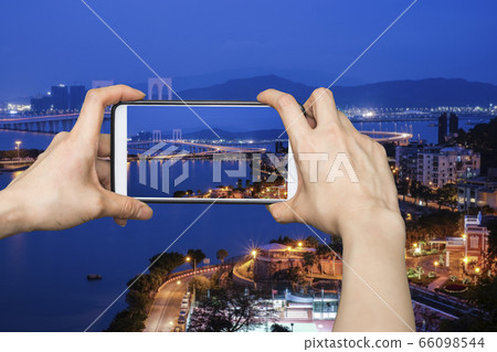 Girl taking pictures on mobile smart phone in View Girl taking pictures on mobile smart phone in View 66098544