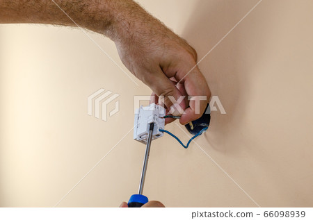 Hands, a screwdriver and wires Hands, a screwdriver and wires 66098939