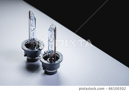 Xenon is a new two lamp for automotive headlights on a gray gradient background. Gas-discharge lighting devices 66100302