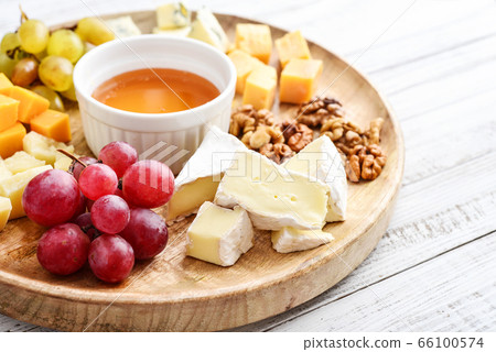 Cheese plate - various types of cheeses with honey 66100574