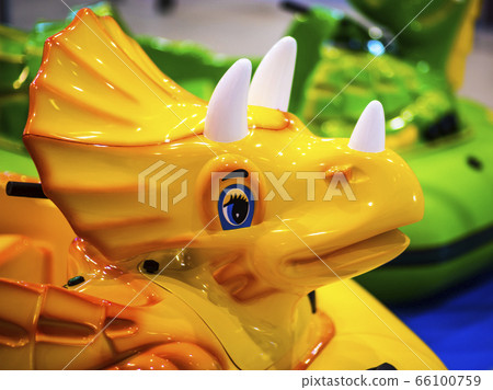 Plastic Mannequin blue-eyed toy dinosaur in a children's park Plastic Mannequin blue-eyed toy dinosaur in a children's park 66100759