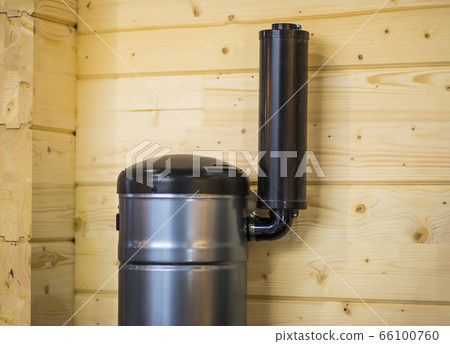 Detail of a chimney on wooden home. Chimney with two steel pipes. Roof and chimney of family house. Detail of a chimney on wooden home. Chimney with two steel pipes. Roof and chimney of family house. 66100760