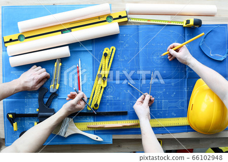 Men draftsmen on table draw construction project 66102948