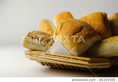 Various types of bread served on a wicker tray, 66103489