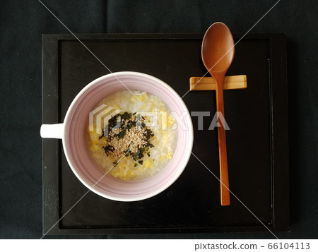 Egg porridge and wooden spoon on a tray Egg porridge and wooden spoon on a tray 66104113