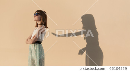 The girl stands in a proud pose. 66104359