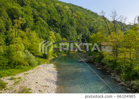 Beautiful view of the Serio river and old bridge 66104965