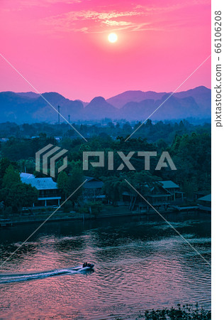 Beautiful glowing pink sunset over the River Kwai in Kanchanaburi Beautiful glowing pink sunset over the River Kwai in Kanchanaburi 66106208