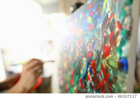 Man paints large bright abstract painting picture Man paints large bright abstract painting picture 66107117