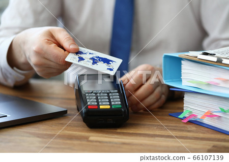 Office employee shows credit card and terminal 66107139