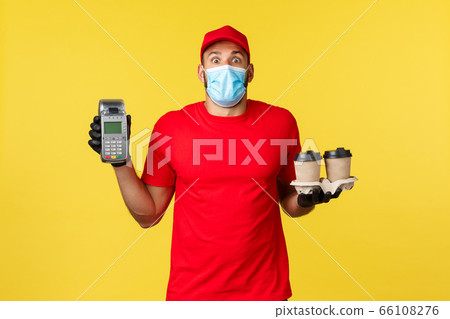 Takeaway delivery, drinks, covid-19 quarantine and preventing virus concept. Surprised gasping courier in red uniform and medical mask, startled stare camera, show POS terminal and coffee order Takeaway delivery, drinks, covid-19 quarantine and preventing virus concept. Surprised gasping courier in red uniform and medical mask, startled stare camera, show POS terminal and coffee order 66108276