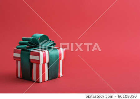 Red striped gift box with green ribbon 66109350