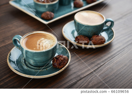 Two cup of coffee and with chocolate cookies 66109656