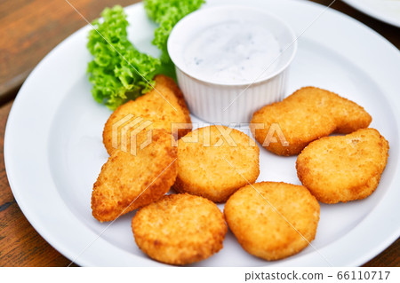 A plate of chicken nuggets on a table A plate of chicken nuggets on a table 66110717