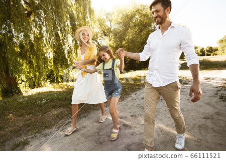 Family Going On Picnic Having Fun Walking Near Riverbank Outside Family Going On Picnic Having Fun Walking Near Riverbank Outside 66111521