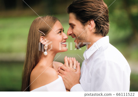 Loving Wedding Couple Holding Hands Saying Vows During Ceremony Outdoors Loving Wedding Couple Holding Hands Saying Vows During Ceremony Outdoors 66111522