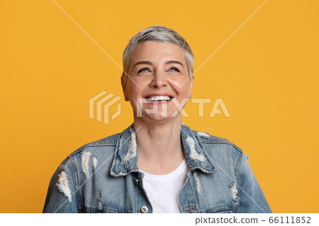 Positive Emotions. Closeup of happy stylish mature woman looking away and laughing Positive Emotions. Closeup of happy stylish mature woman looking away and laughing 66111852