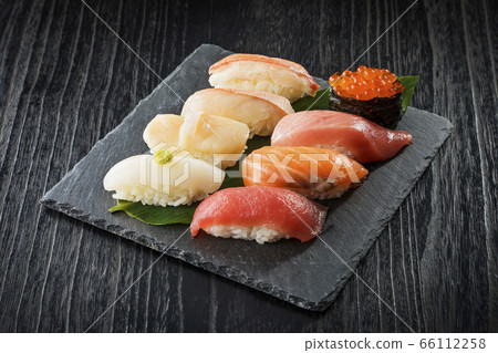 Assorted nigiri sushi on a black plate Assorted nigiri sushi on a black plate 66112258