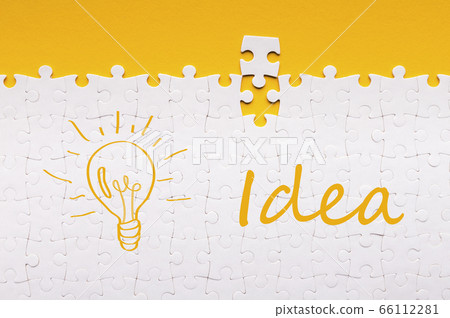 Last detail for assembled white puzzle with inscription and lit lamp 66112281