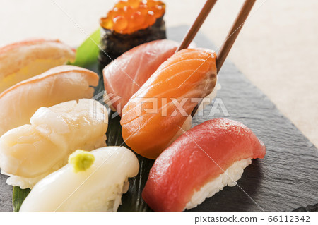 Assorted sushi on a black plate Assorted sushi on a black plate 66112342