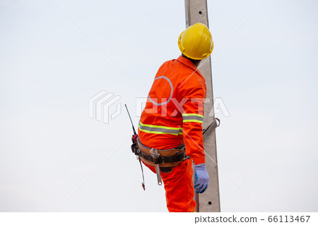 Uniformed electricians working on high-voltage 66113467