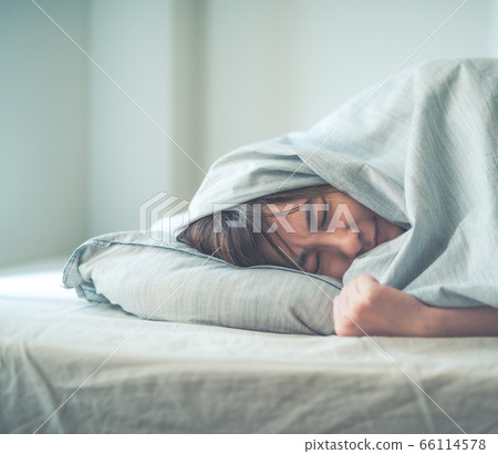 Woman in bedroom at home 66114578
