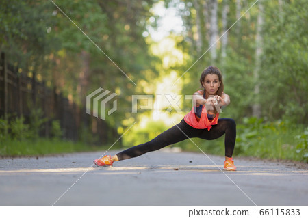 Sport and healthy lifestyle concept - woman stretcing muscles. Sport and healthy lifestyle concept - woman stretcing muscles. 66115833