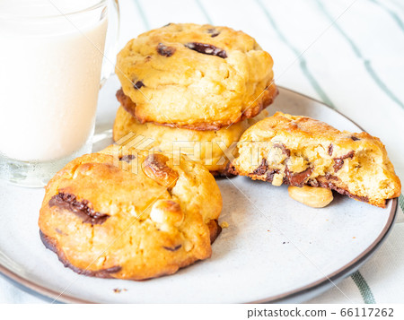 Chewy chocolate chip soft cookies with cup of milk Chewy chocolate chip soft cookies with cup of milk 66117262