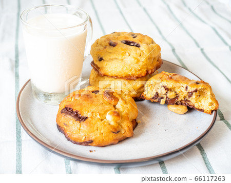 Chewy chocolate chip soft cookies with cup of milk 66117263