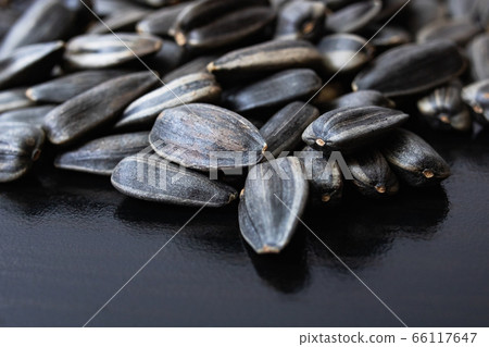 Sunflower seed on a black wooden table 66117647