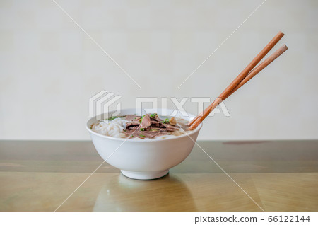 Traditional Vietnamese beef soup pho on a wooden background Traditional Vietnamese beef soup pho on a wooden background 66122144