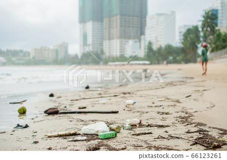 Beach pollution. Plastic bottles and other trash on sea beach 66123261