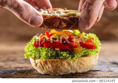 Composing a burger, placing the meat part onto Composing a burger, placing the meat part onto 66124145