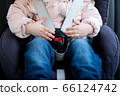 Hands of a little girl lie on the seat belt buckle 66124742