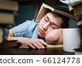 girl student who fell asleep while studying at home in the evening 66124778