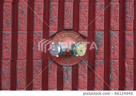 Built-in old fire hydrant on a building 66124948