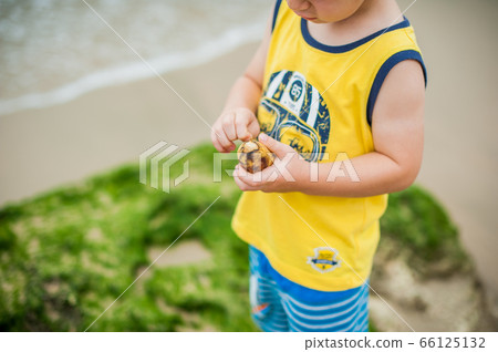The boy cleans a banana 66125132