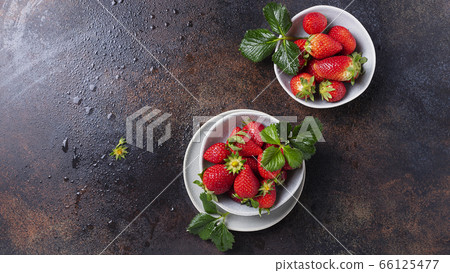 Fresh strawberry with a green leaves Fresh strawberry with a green leaves 66125477